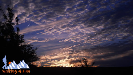 Sunset with scattered clouds and a silhouetted foreground